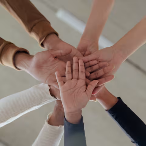 Hands in a huddle ready to do a high-five